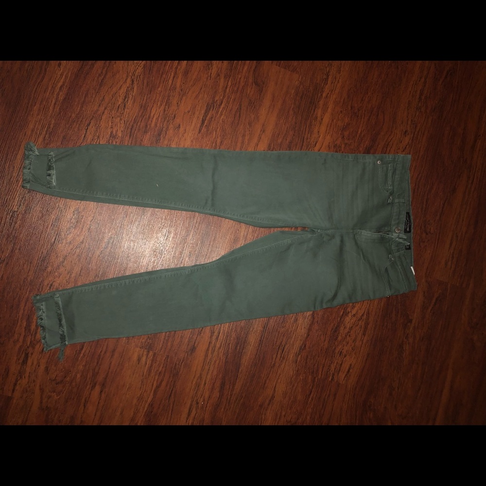 Army green pants with fringed bottoms